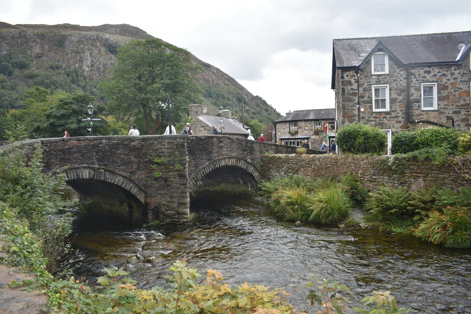 A stone bridge over a river in a village