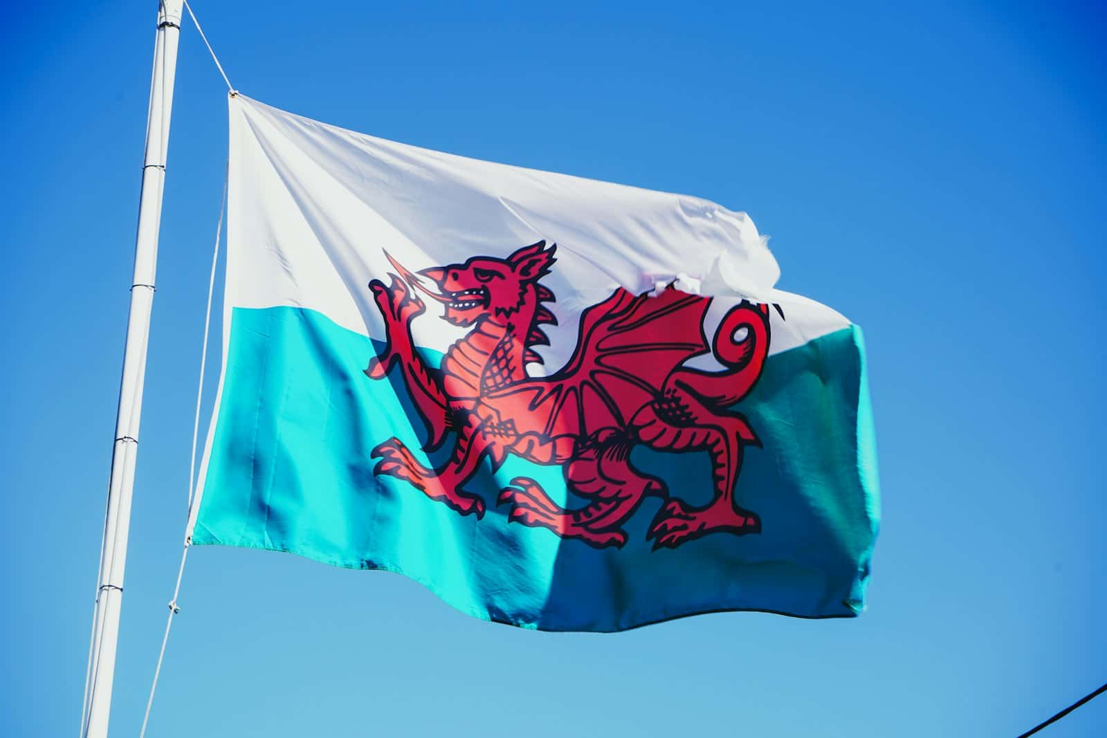 The Welsh flag flying against a blue sky
